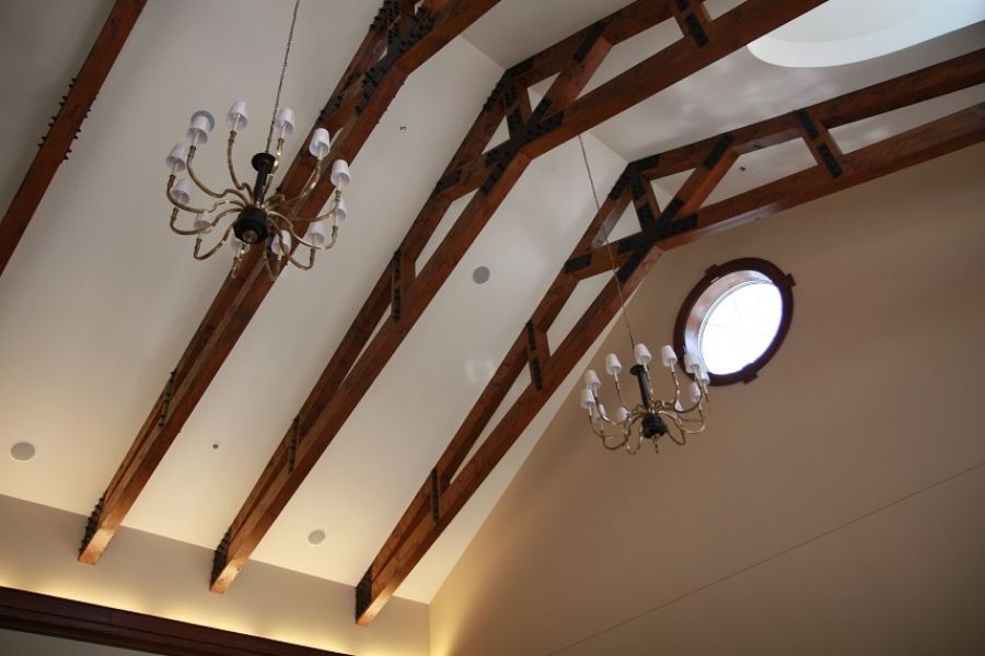 vaulted ceiling with exposed dark wood timber trusses