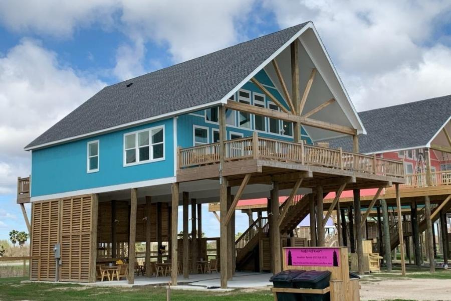 gun barrel pilings and timber truss beach home